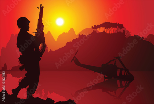 Soldier with crashed helicopter on the background