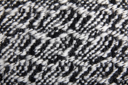 Knitted black and white wool fabric, background