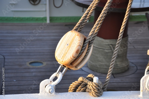 Old wooden pulley in a ship photo