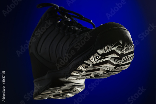 sports winter boots on blue background