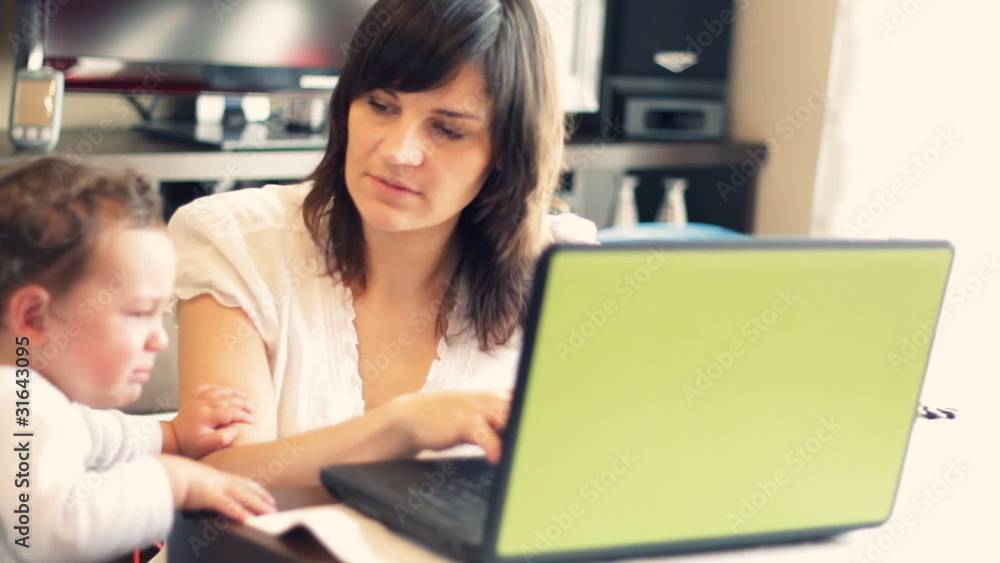 Mother with baby working on the laptop v2 Mother with baby working on the laptop v2