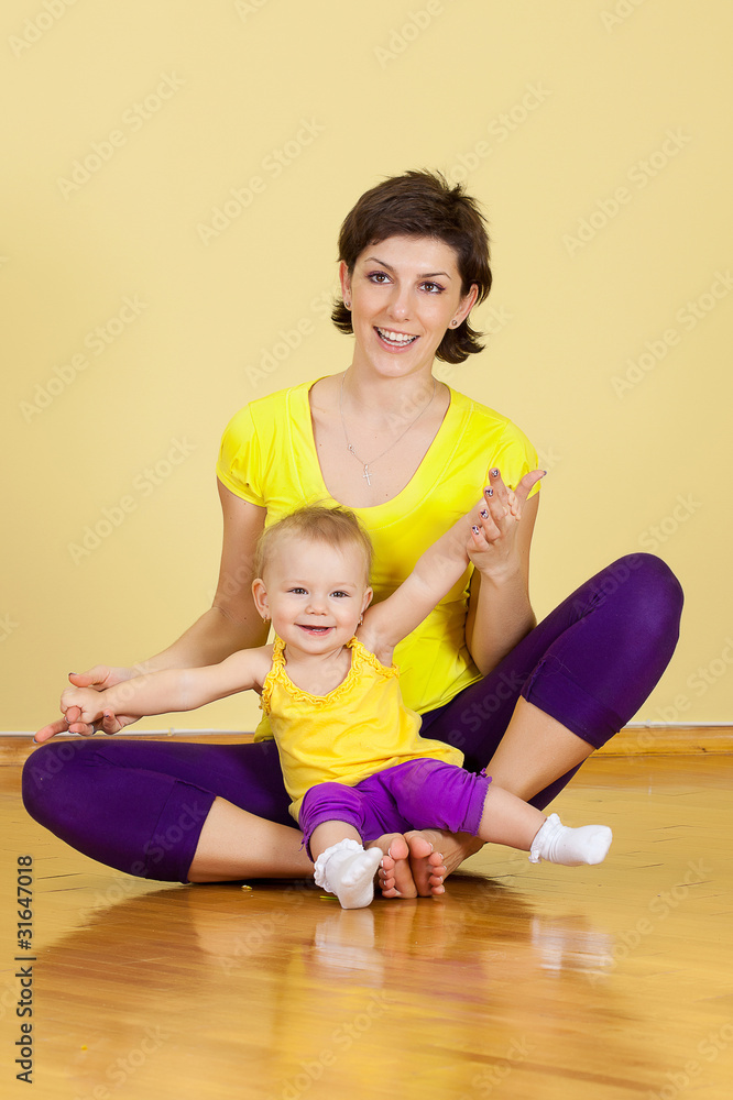 mother does fitness exercises together with her baby mother does fitness exercises together with her baby