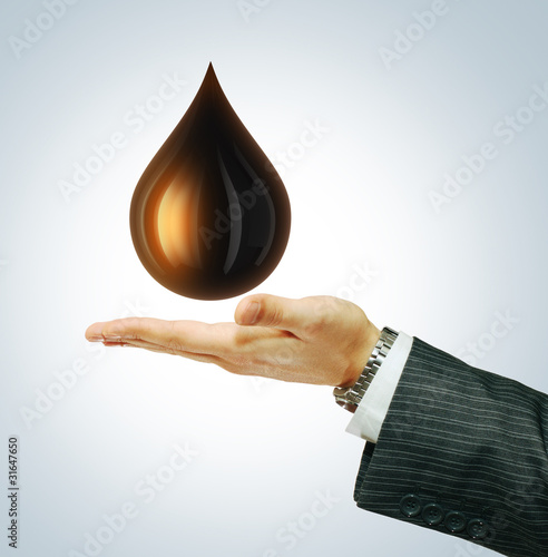 Oil Drop on businessman hend photo