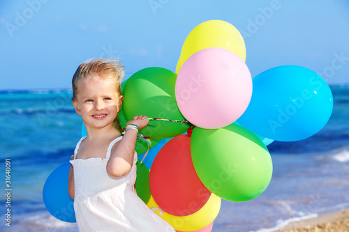 Child playing with balloons .