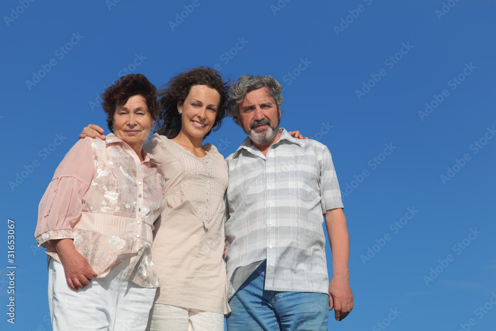 adult daughter and parents embracing and smiling adult daughter and parents embracing and smiling