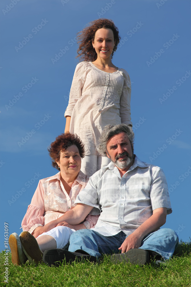 adult daughter and her parents on summer lawn adult daughter and her parents on summer lawn