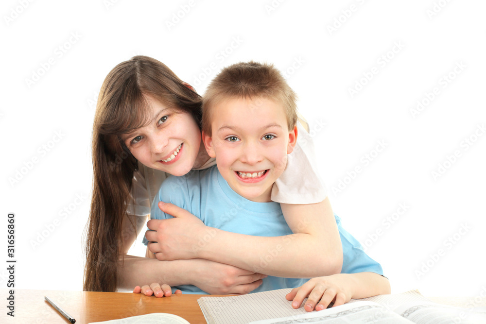 happy brother and sister on the table with exercise books happy brother and sister on the table with exercise books