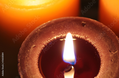 Burning brown candle photo