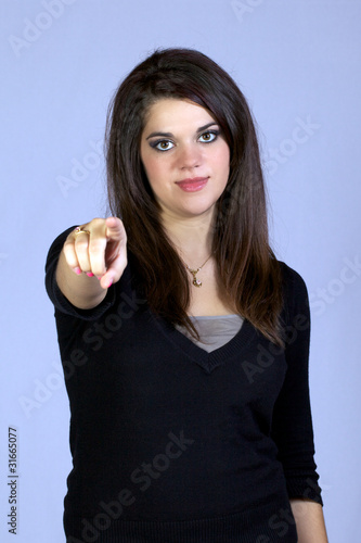 Wallpaper Mural Young adult woman pointing with purpose Torontodigital.ca