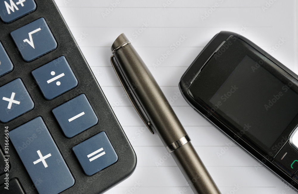 pen, mobile phone and a calculator pen, mobile phone and a calculator