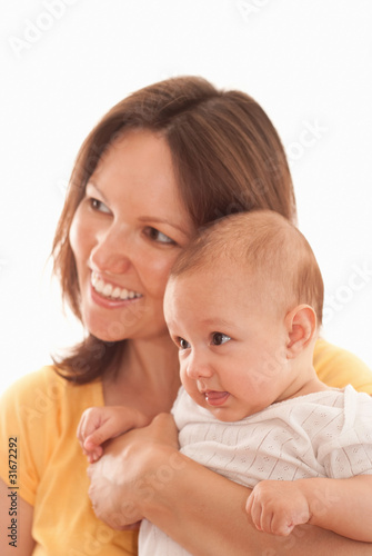 mother in yellow holding newborn