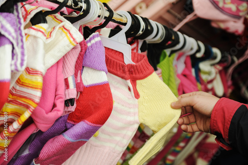 Close-up of a female customer looking for children clothes