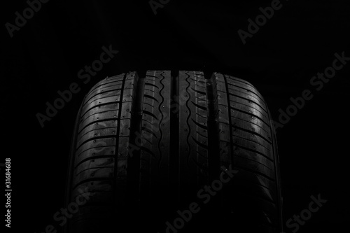 Car tire on black background © Kavita