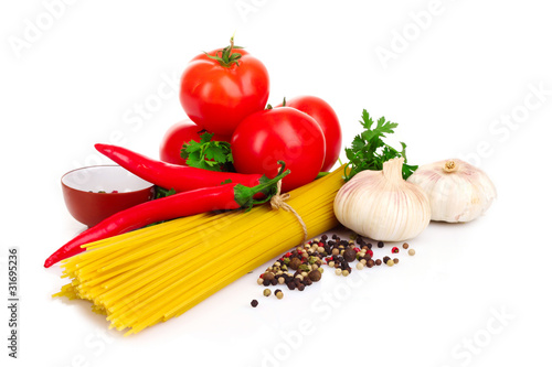 Pasta spaghetti with tomatoes, olive oil and basil on a white ba