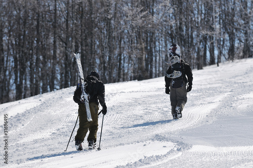 skier hike on mountain peak at winter