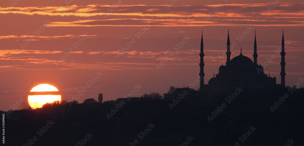 Sunset View of Mosque silhouette and sun 