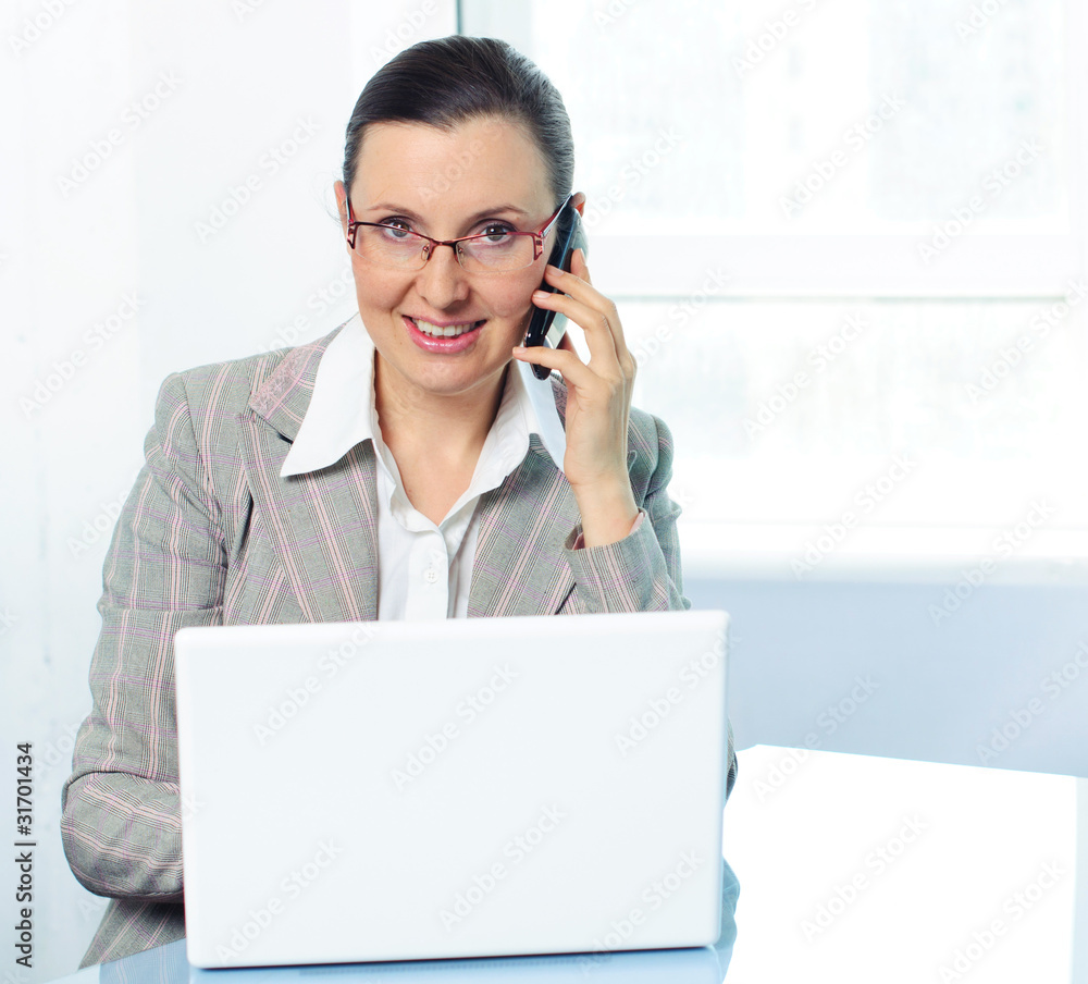 smiling young business woman with glasses using laptop smiling young business woman with glasses using laptop
