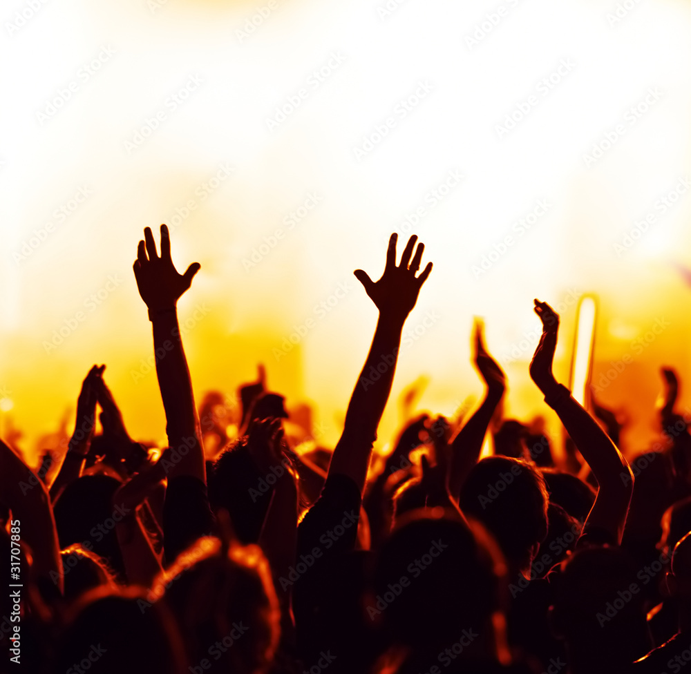 concert crowd in front of bright blue stage lights