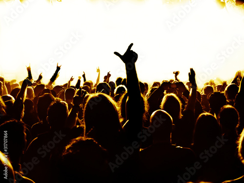 concert crowd in front of bright blue stage lights