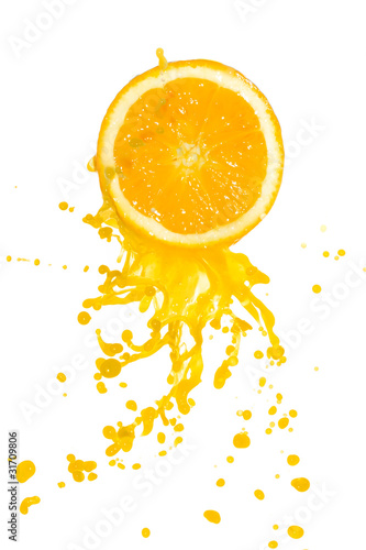 orange juice splashing from cut orange, isolated