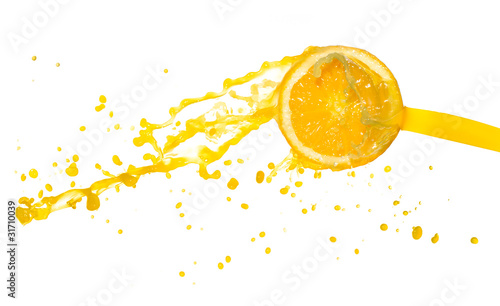 orange juice splashing from cut orange, isolated