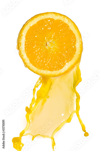 orange juice pouring from cut orange fruit