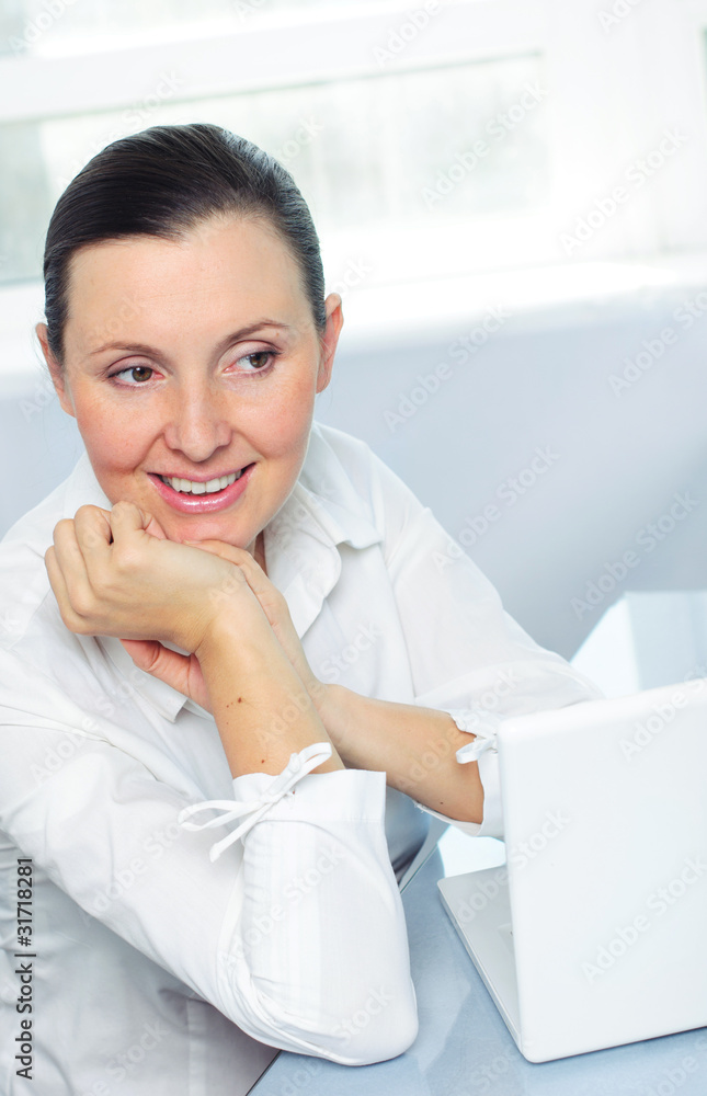 smiling young business woman using laptop smiling young business woman using laptop