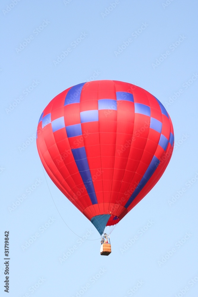 Fototapeta premium Red and blue hot air balloon flying