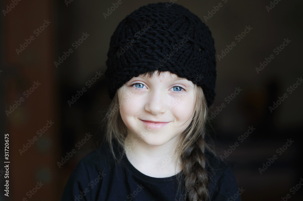 Portrait of cute little girl in black hat on dark background Portrait of cute little girl in black hat on dark background