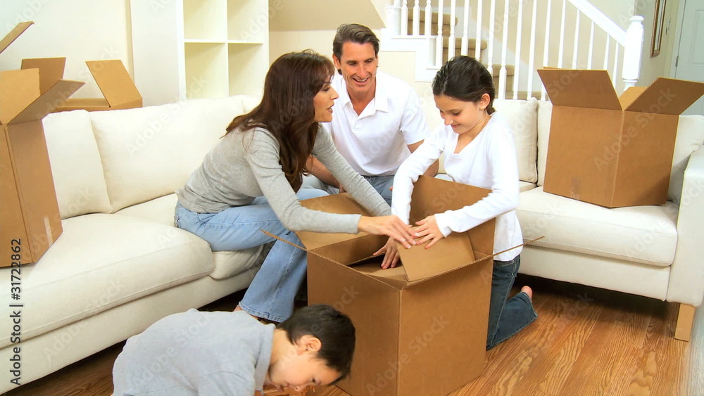 Family Packing up Cardboard Moving Cartons Family Packing up Cardboard Moving Cartons