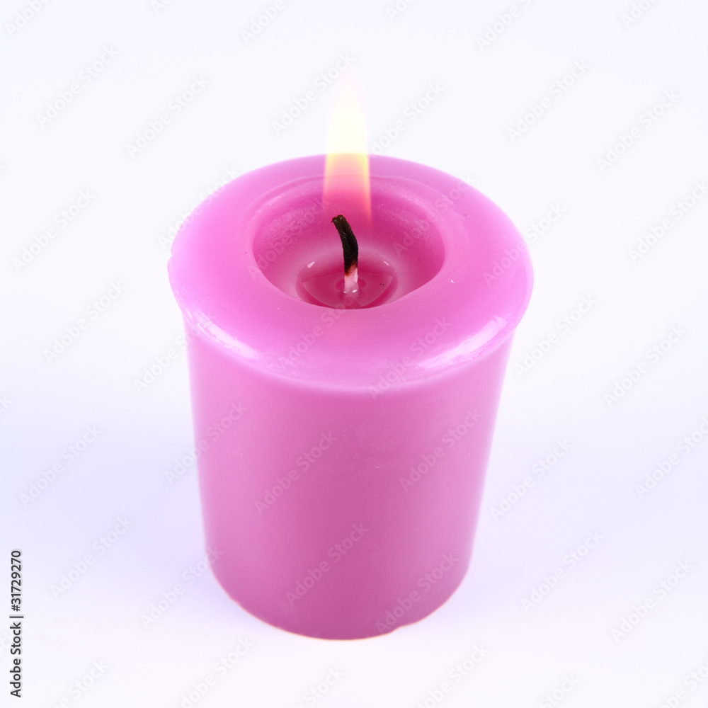 Lavender candle burning on a white background Lavender candle burning on a white background