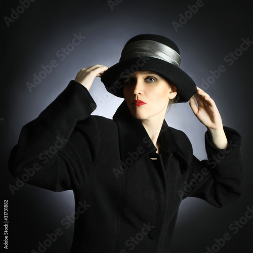 Fashion portrait of beautiful woman in black hat