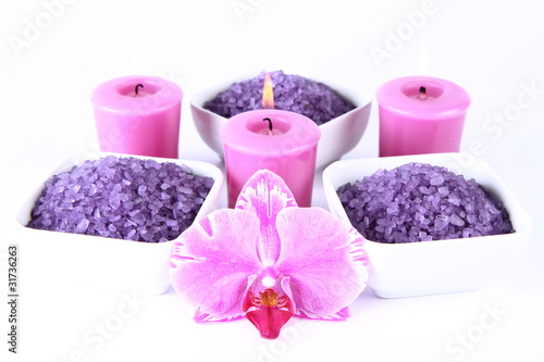 Lavender spa salt  candles and an orchid flower on white