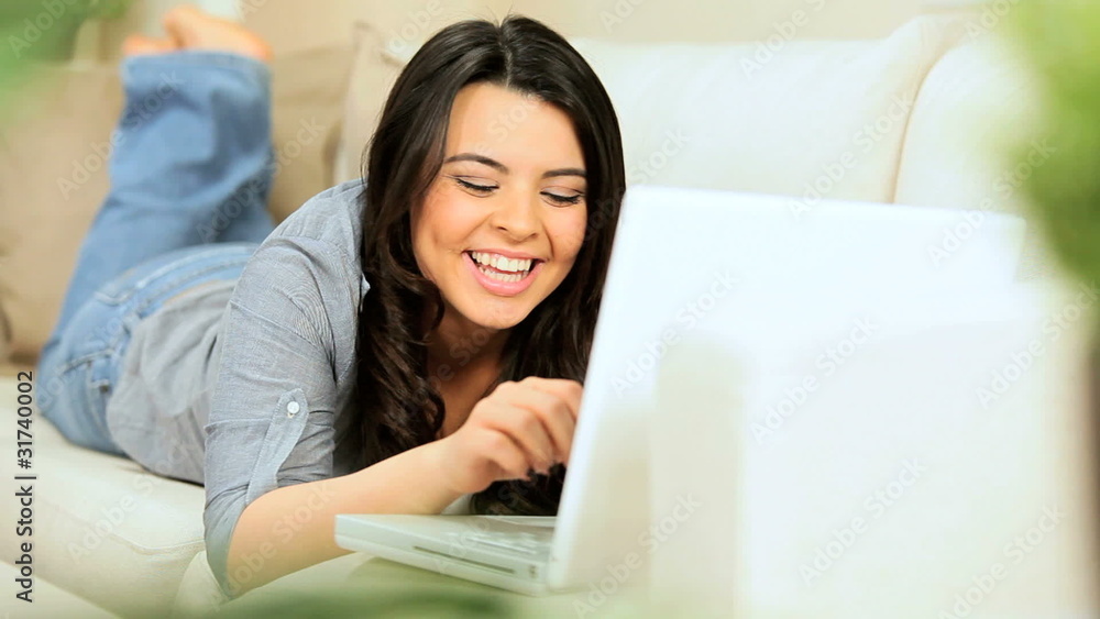 Brunette Girl at Home Using a Laptop Brunette Girl at Home Using a Laptop