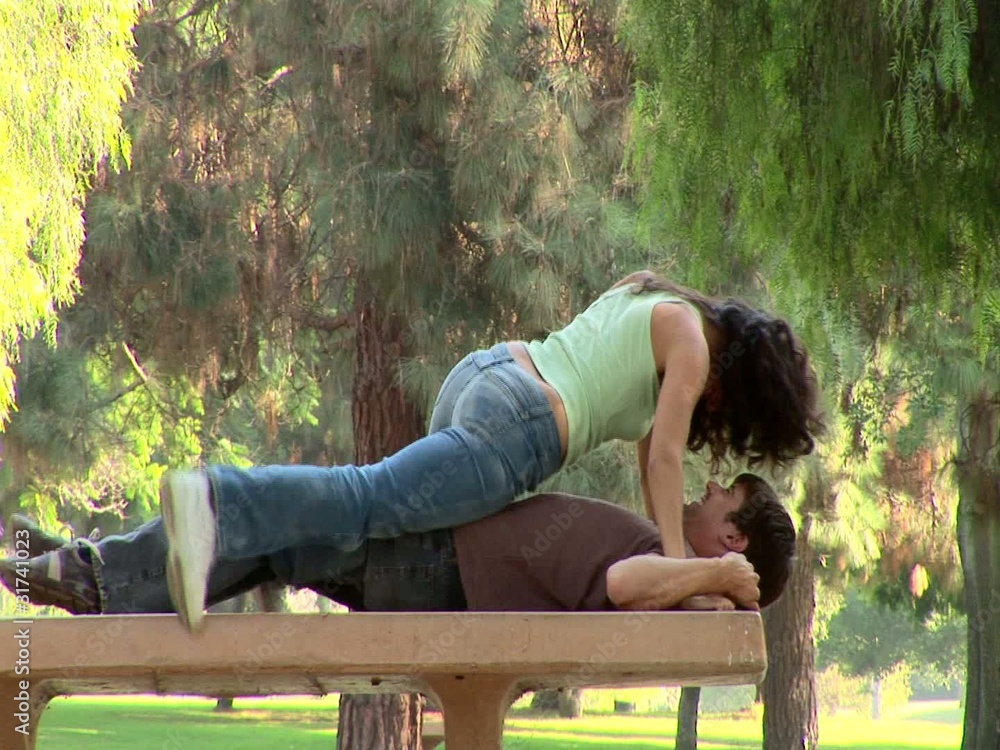 Young couple being affectionate in a park Young couple being affectionate in a park