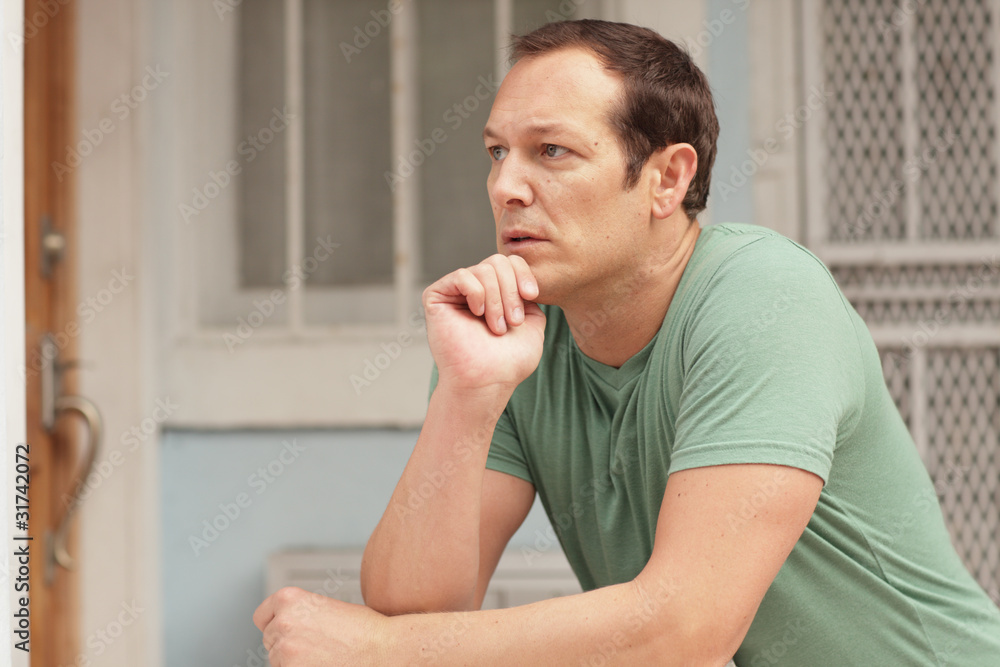 Man pondering on the ledge Man pondering on the ledge