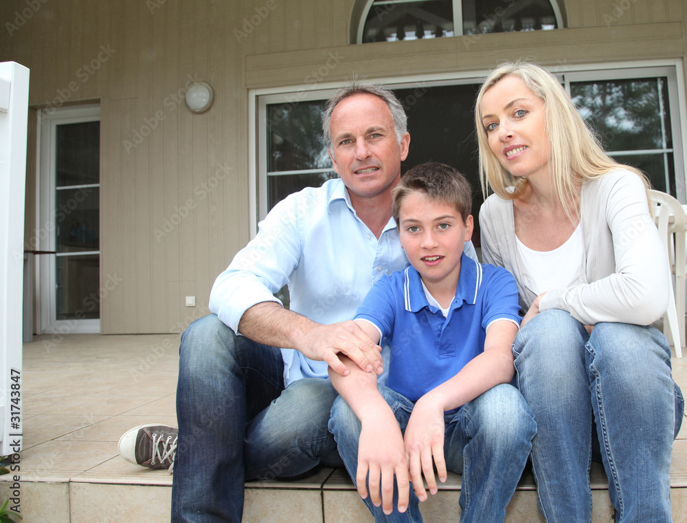 Portrait of family sitting on the front door stairs Portrait of family sitting on the front door stairs