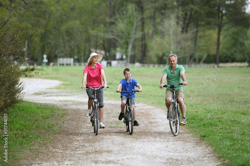 Family riding bicycles in countryside © goodluz