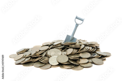 Shovel standing in pile of coins