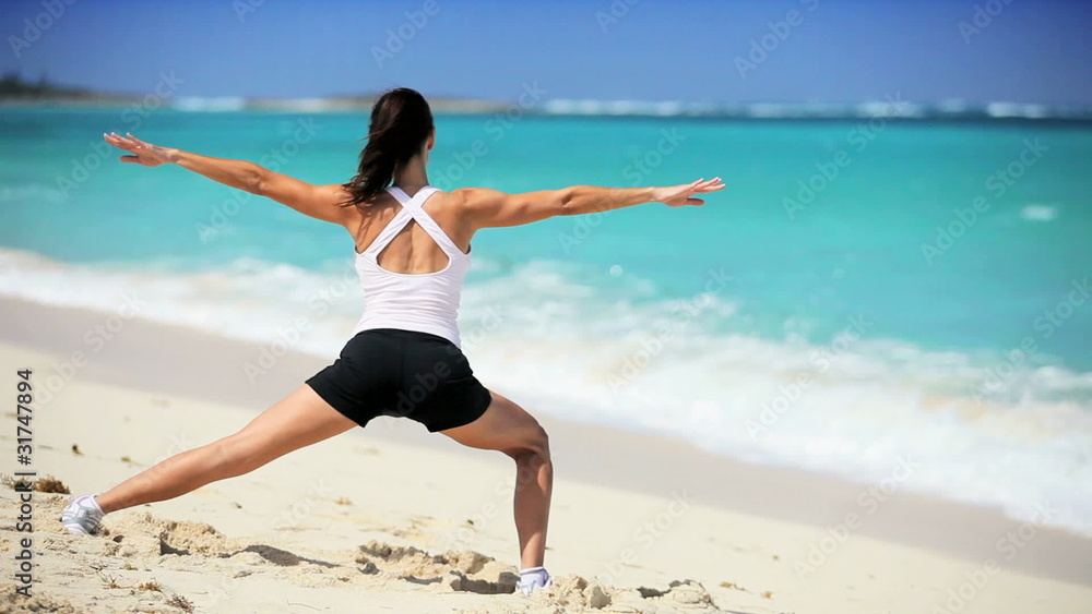 Healthy Female Doing Stretches on the Beach Healthy Female Doing Stretches on the Beach