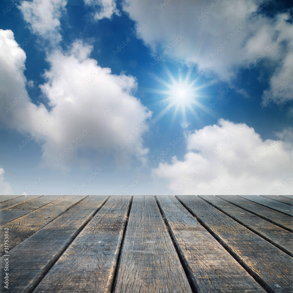 Old wood floor perspective under bright blue sky