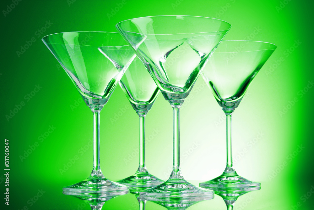 empty glasses of martini on the green background empty glasses of martini on the green background
