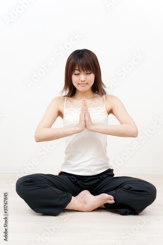 beautiful asian woman playing yoga style exercise