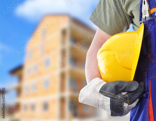 Worker with blurred construction in background