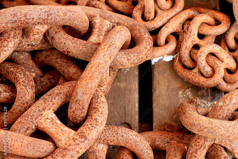 Old rusty chain on wooden background Old rusty chain on wooden background