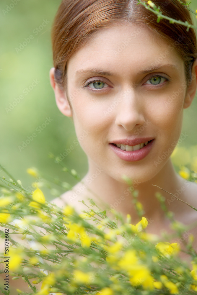 Portrait of beautiful woman in field of flowers