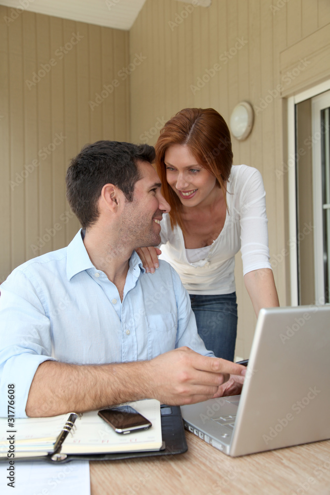 Self-employed man working at home with wife Self-employed man working at home with wife