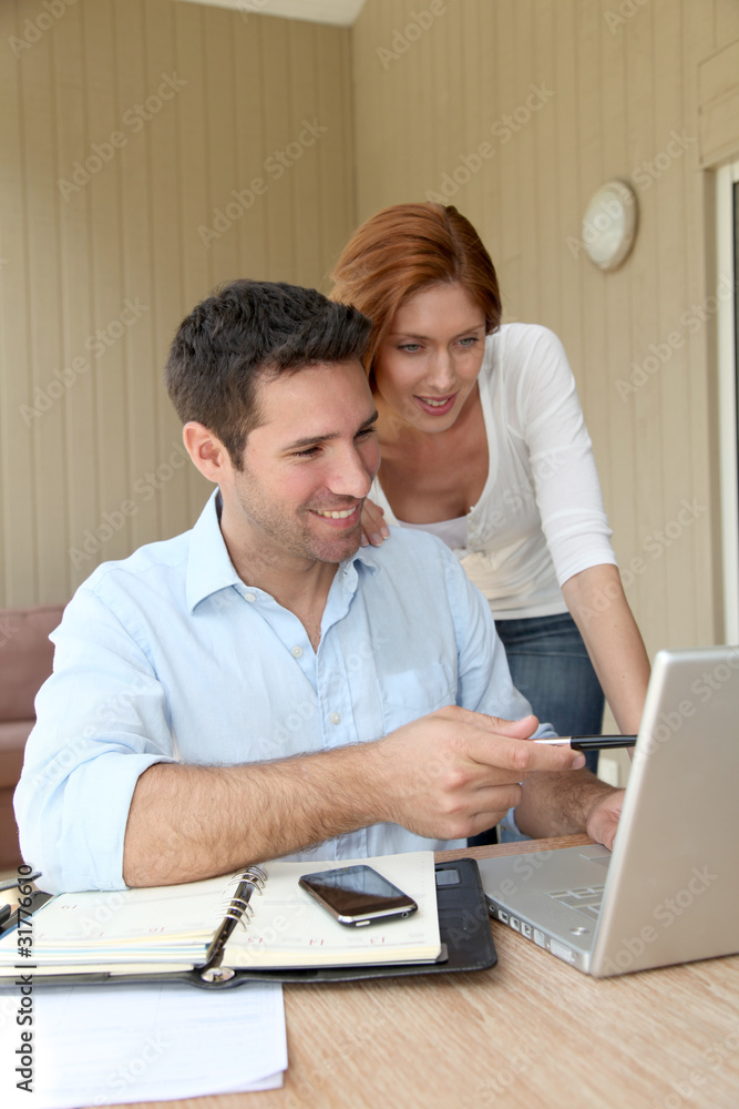 Self-employed man working at home with wife Self-employed man working at home with wife
