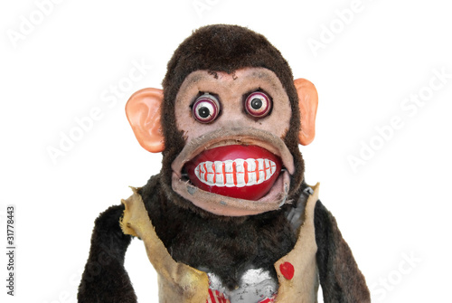 Photo Damaged mechanical chimp with ripped vest, uneven eyes