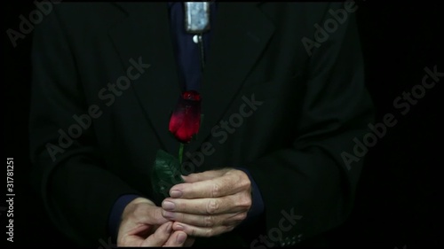 Magician creates a rose from a ball of fire. photo